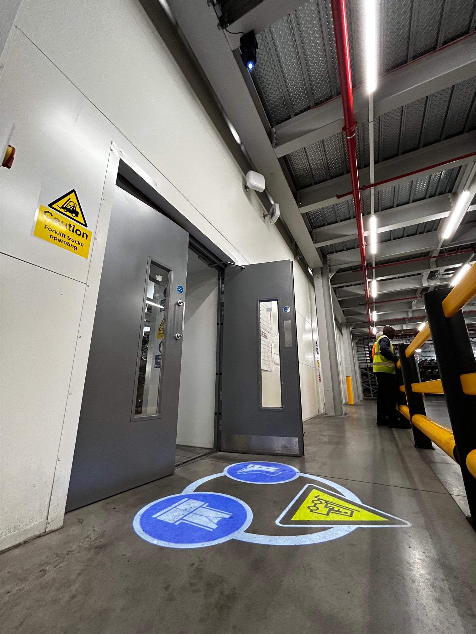 Projected safety signage is critical for warehouse automation.