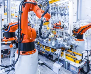 robotic arms in a car plant