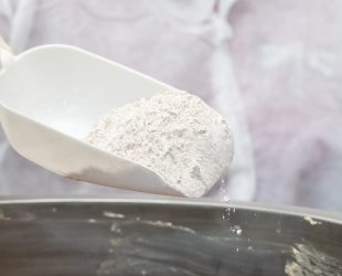 Adding flour into frying metallic pan. High quality photo