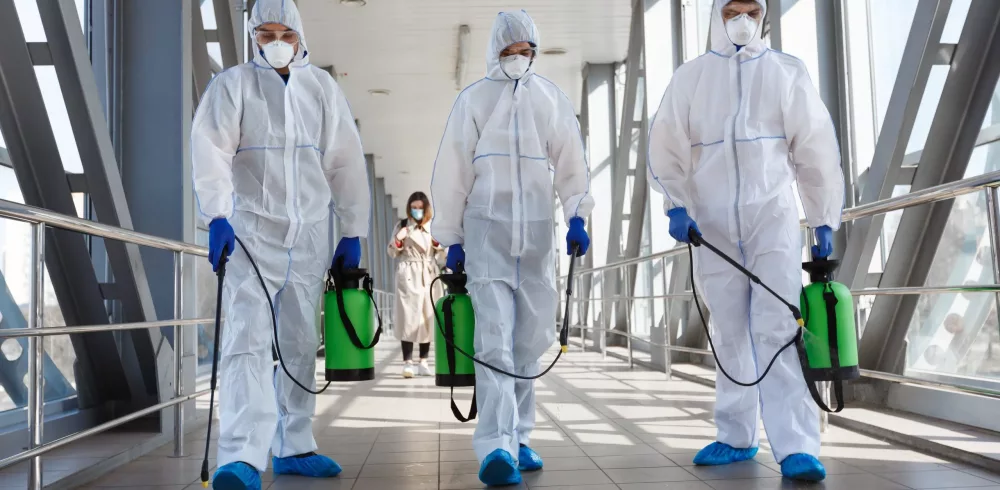 PPE-Suits-Walking-Spraying-scaled-1