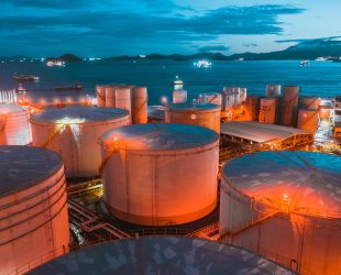 oil tanker and oil tank in port at night