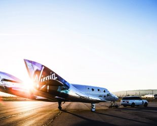 Virgin Spaceship Unity is unveiled in Mojave, California, Friday February 19th, 2016 and christened by Richard Branson's Granddaughter, Eva-Deia who turned 1 years old that same day.

VSS Unity is the first vehicle to be manufactured by The Spaceship Company, Virgin Galactic's wholly owned manufacturing arm, and is the second vehicle of its design ever constructed. VSS Unity was unveiled in FAITH (Final Assembly Integration Test Hangar), the Mojave-based home of manufacturing and testing for Virgin Galactic's human space flight program. VSS Unity featured a new silver and white livery and was guided into position by one of the company's support Range Rovers, provided by its exclusive automotive partner Jaguar Land Rover.