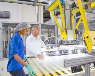 Engineer and Technician working on coating glass for use in production of solar panels