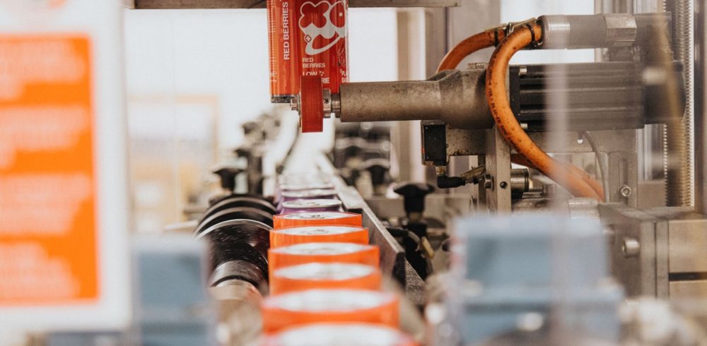 Concept-to-shelf drinks development: cans moving along a production line at Prism