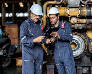 In heavy industry maintenance manager meet engineer checking and agreement hand check and sign on work schedule to overhaul mega 1000 horse power machine with electric generator supercharger turbo