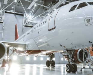 In Aircraft Maintenance Hangar Standing Clean Brand New Plane.