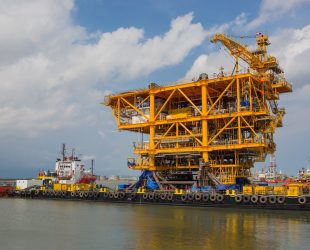 Oil rig topside on a barge before sailing away