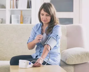 Women checking blood pressure at home