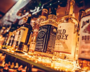 BUCHAREST, ROMANIA - March 22, 2017: Editorial image of some alcohol bottles in a row, displayed in a pub or restaurant.