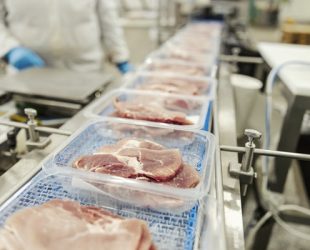 Close up of a meat on a packing machine.